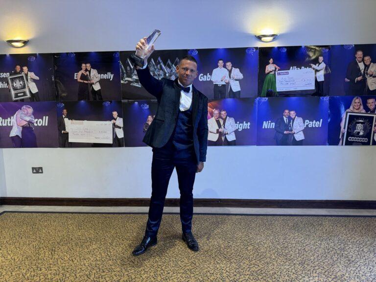 Liam J. Ryan, co-founder of Assets For Life, proudly raises the Business Growth Award bestowed by the Professional Speakers Academy, symbolizing the company's innovative success in property education and wealth training. (Photo from Liam J. Ryan)