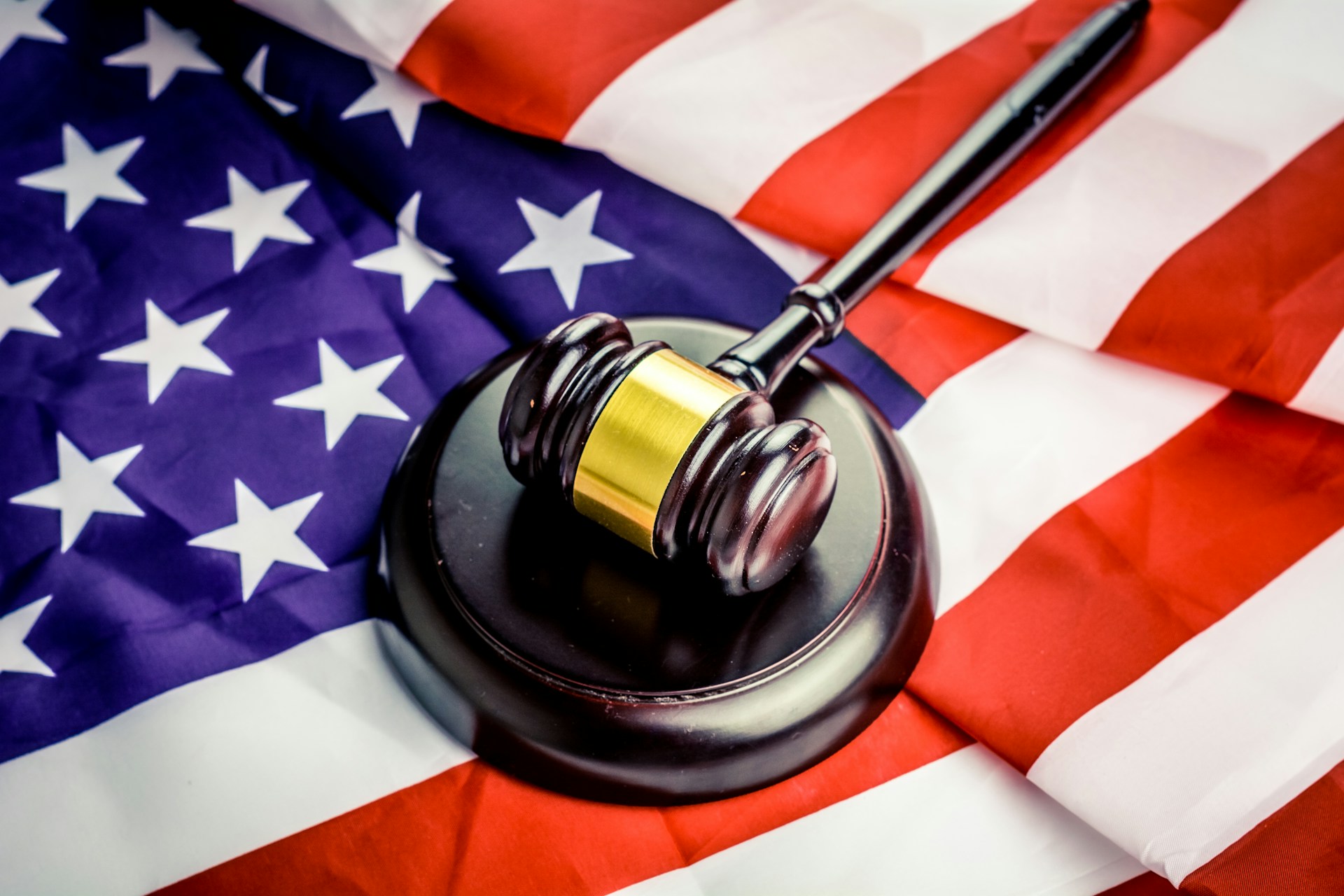 Image shows the top-down view of an irregularly folded US flag with a gavel on top.