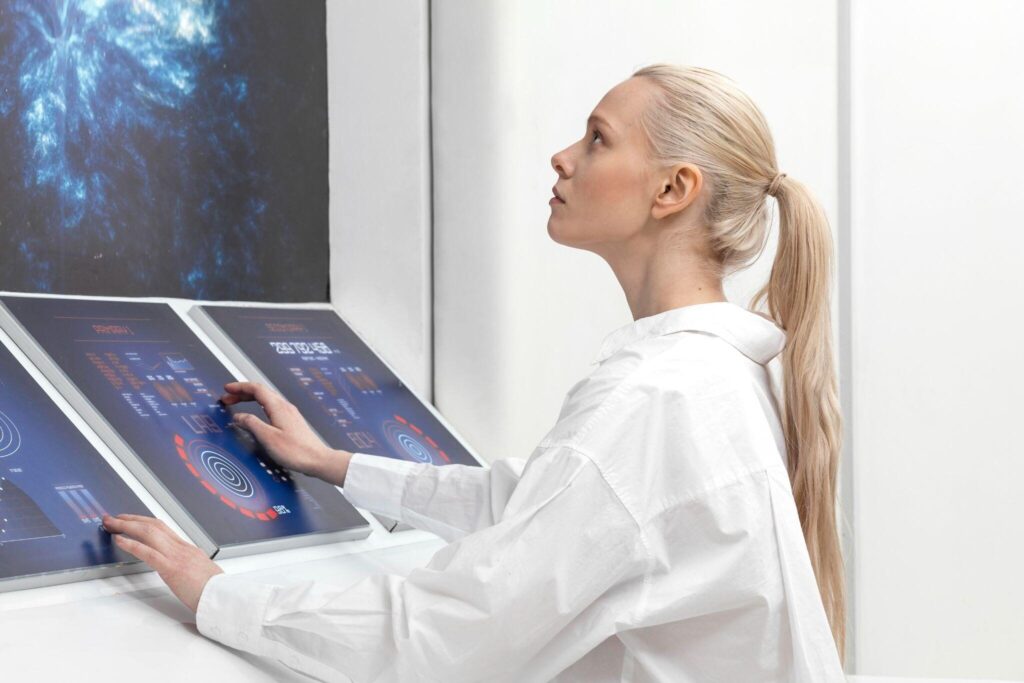 Researcher in white coat working with futuristic digital touch screens in lab setting