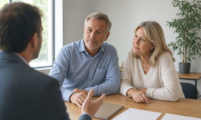 Couple in their fifties meeting with a financial advisor at a conference table