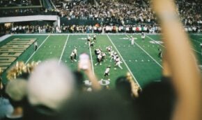 American football game in a stadium with spectators