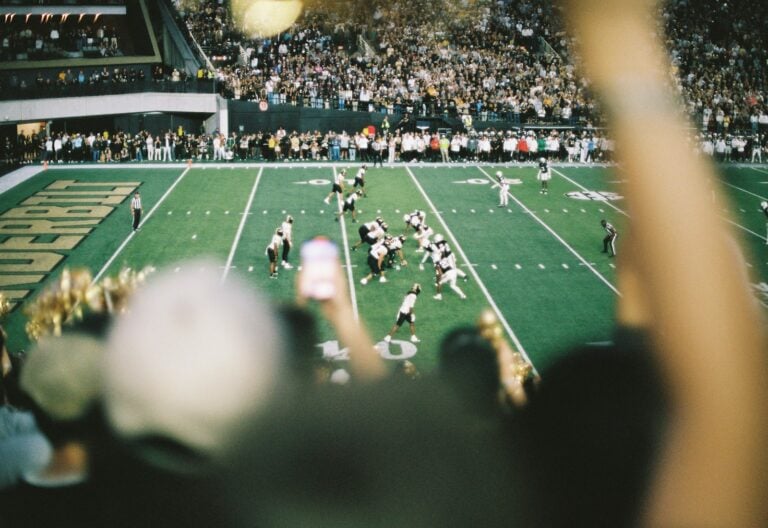 American football game in a stadium with spectators